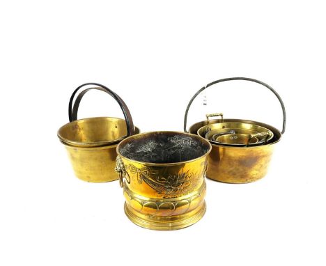 Six brass jam pans; and a brass planter. (7)