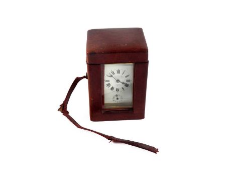 A brass-cased carriage clock, with enamelled dial, alarm movement and key, 11cms, in fitted leather bound travelling case.