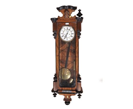 An early 20th Century walnut and ebonised wood 8-day Vienna wall clock, with white enamel Roman dial and subsidiary second di