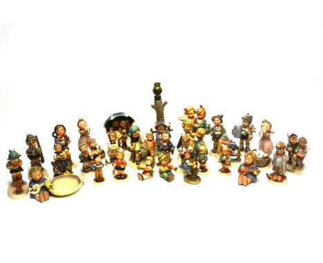 A collection of Goebel Hummel figures, including: an ashtray decorated with a girl playing guitar and a bird; a girl with a l