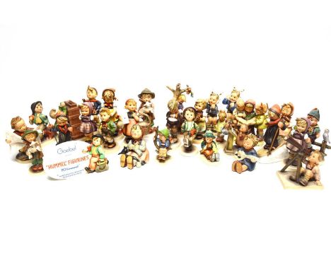 A collection of Goebel Hummel figures, including: a ‘"Hummel” Figurines’ plaque; a boy looking through a telescope; a boy ski