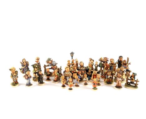 A collection of Goebel Hummel figures, including: 196 ‘Telling her secret’; ‘Signs of spring’; 316 ‘The mountaineer’; and oth