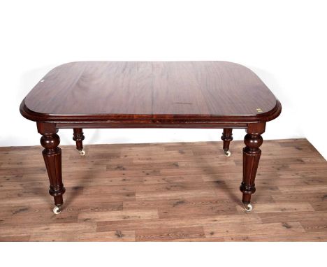 A Victorian mahogany extending dining table, with rounded rectangular moulded top opening to receive two additional leaves, r