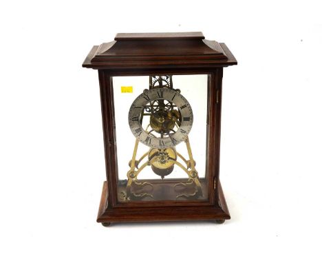 A late 19th Century oak skeleton mantel clock, with silvered Roman chapter ring, with single fusee movement, the case with mo