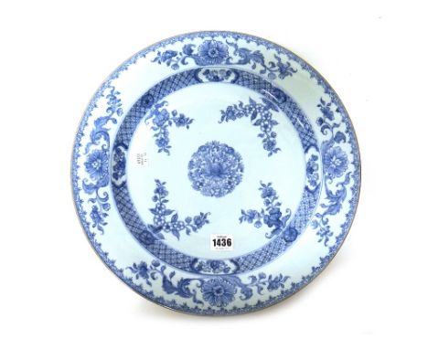 A large pair of Chinese export porcelain blue and white dishes, Kangxi, each painted with a central foliate roundel inside fo