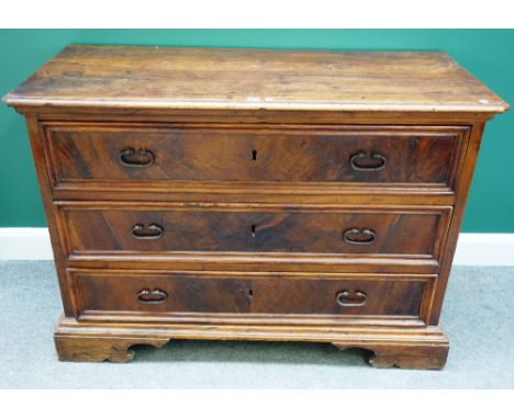 An early 18th century Italian walnut three drawer commode, on bracket feet, 126cm wide.