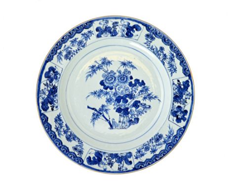 A large Chinese export porcelain blue and white dish, Kangxi, painted in the centre with chrysanthemum, bamboo and lotus, ins