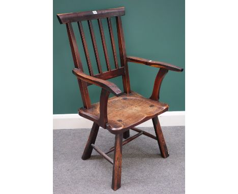 An early 19th century oak and fruitwood stick back Windsor chair, with saddle seat, on splayed tapering chamfered square supp