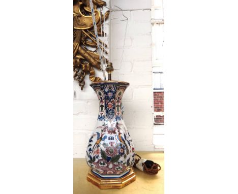 A French faience vase (converted to a table lamp), 19th century, decorated with flora and fauna against an octagonal baluster