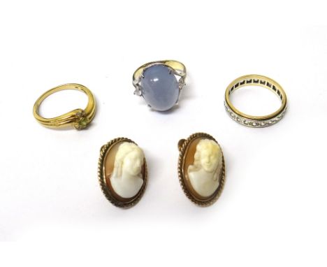 A 9ct gold, diamond and green gem set ring, in a crossover design, a diamond and cabochon blue stained agate set three stone 