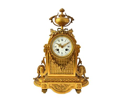 A 19th century French gilt metal mantel clock, the white enamel dial detailed 'Degas A Paris', with urn surmount and an ornat