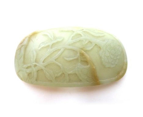 A Chinese celadon jade oval plaque, 19th/20th century, carved with flowering peony, 9cm.high.