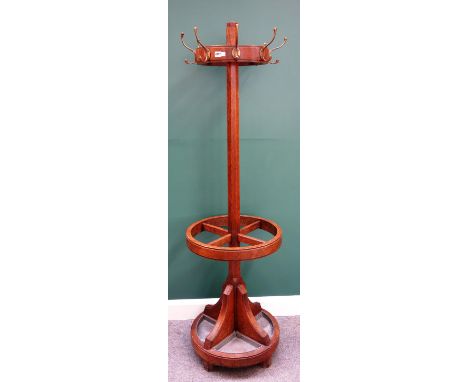 An early 20th century oak coat and umbrella stand, the halo ring mounted with eight coat hooks, on tapering octagonal column 