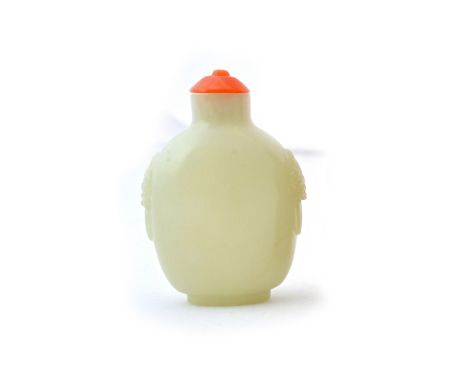 A Chinese jade snuff bottle, 19th century, of ovoid form, carved with lion mask and ring handles, 6cm. high. Illustrated. 