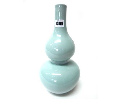 A Chinese porcelain vase of double gourd form, covered in a a light greenish blue glaze, apochryphal Qianlong seal mark, 32cm