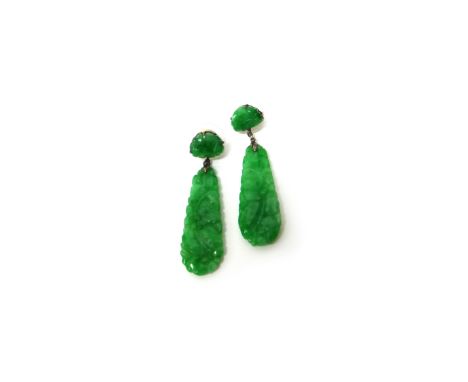 A pair of carved jade pendant earrings, each in a drop shaped design, decorated with flowers and with a carved jade surmount,