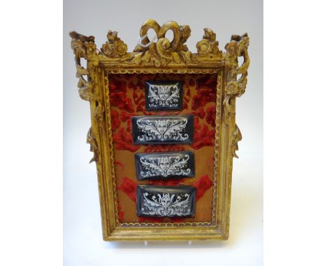Four Limoges enamel on copper plaques, late 19th century, each of raised rectangular form, painted with masks and scrolling f
