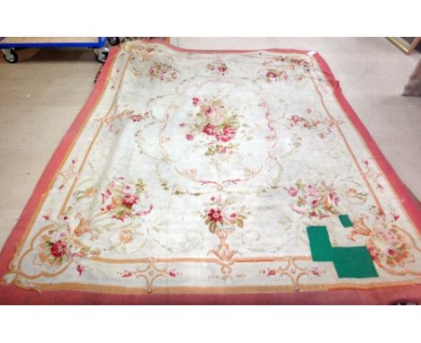 An Aubusson carpet, the ivory field with a delicate cartouche of abundant floral bouquets, outer border, 319cm x 244cm.Proper