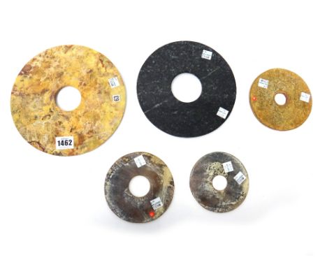 A group of five Chinese archaistic jade bi discs, each plain and of various tones, 11cm.diameter to 21cm. diameter.