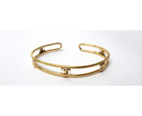 A Cartier gold bangle, with five interlocking 'C' motifs, detailed Cartier 18 K, weight 12.2 gms.