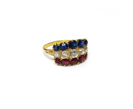 A gold, diamond, ruby and sapphire ring, mounted with a row of five graduated cushion shaped diamonds to the centre, a row of