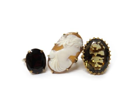 A gold mounted oval shell cameo ring, carved as the portrait of a lady, a 9ct gold ring, claw set with an oval cut smoky quar