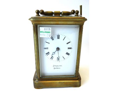 A gilt brass cased carriage clock, late 19th/early 20th century, the white enameled dial detailed 'Tradling Newbury' with a s