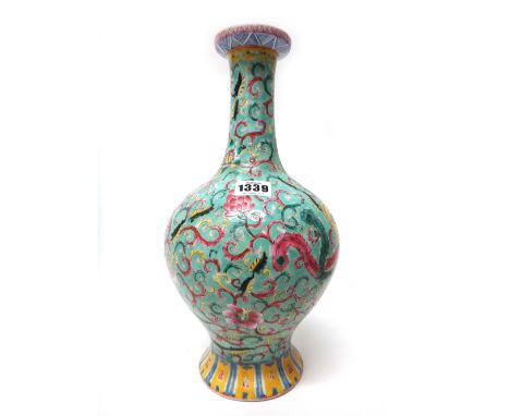 A Chinese famille-rose baluster vase, circa 1900, painted with a dragon and phoenix amongst flowers and foliage against a gre