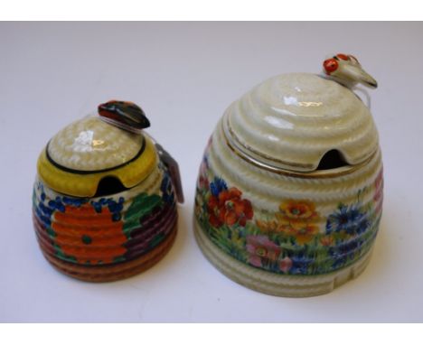A Clarice Cliff beehive preserve pot and cover, decorated in the 'Gay Day' pattern, 7cm high, and one further Clarice Cliff b