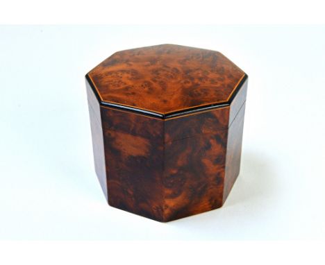 A 19th century ebony and boxwood strung amboyna octagonal tea caddy, 12cm wide. Illustrated. 