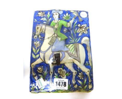 A Qajar pottery rectangular tile, late 19th century, moulded and painted with a falconer on horseback, (a.f), 20cm. by 14.5cm