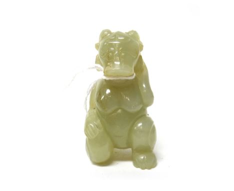 A Chinese pale celadon jade mythical creature, with ram's head and human body, carved in kneeling pose, the stone with russet