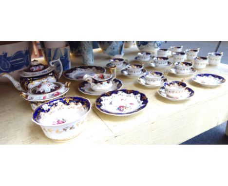 A Ridgway matched part tea service, 19th century, decorated with gilt flowers against a white and cobalt blue banded ground, 