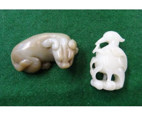 Two Chinese jade carvings of animals, comprising; a Ming-style green and russet jade recumbent lion, 7.5cm. length, and a whi
