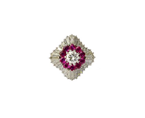 A platinum, diamond and ruby set cocktail ring, claw set with the principal circular cut diamond at the centre, within a surr