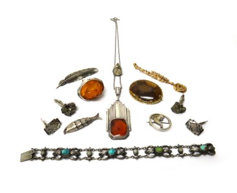 A group of jewellery, comprising; two pairs of cufflinks, an oval agate set brooch, two further brooches, a carved amber ring