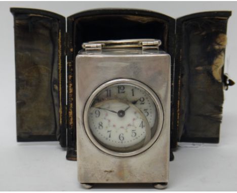 A silver rectangular cased carriage clock timepiece, the floral decorated enamelled dial with black Arabic numerals, the case
