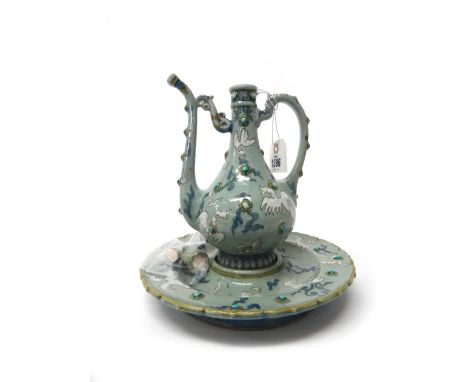 A Lachenal earthenware ewer and basin in Persian style, French , circa 1880, each painted with stylised white birds amidst bl
