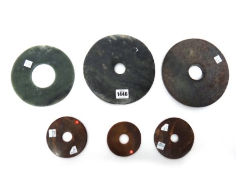 A group of six Chinese jade bi discs of various colour and size, 8.5cm. to 18.5cm. diameter.