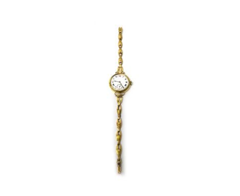 A lady's 18ct gold circular cased wristwatch, with a gilt jewelled lever movement, 18ct gold inner case, the enamelled dial w
