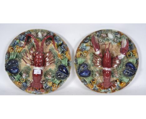 A pair of large ceramic continental glazed majolica lobster plates with heavy glazed embellished surrounds