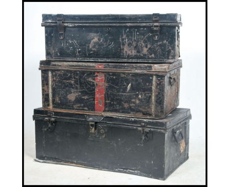 A collection of 3 Victorian metal steamer trunks to include an ebonised Victorian military campaign trunk with remains of not