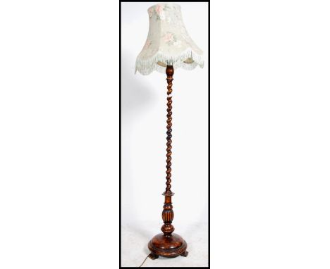 An Edwardian fruitwood standard lamp  having a stunning barley twist column with shade surmounted atop. The barleytwist colum