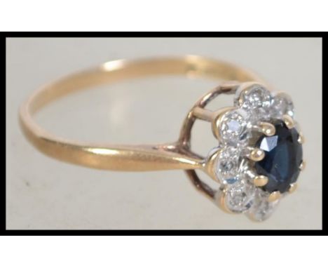 A 9ct gold hallmarked sapphire and diamond ring having a central oval sapphire stone with illusion set surround and low point