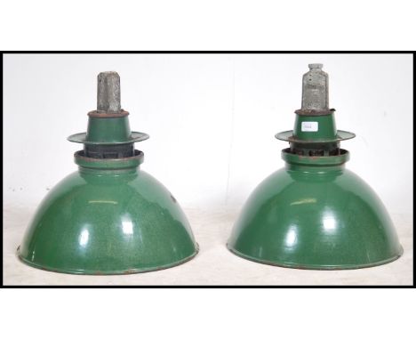 A pair of large vintage 20th century industrial factory green enamel pendant ceiling lights
