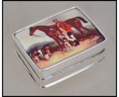 A silver pill box with inset enamel pictorial of a horse and rider ( equestrian / hunting interest ) to the hinged lid. Total