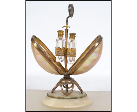 A 19th century Continental mother of pearl and gilt metal perfume bottle holder, the alabaster base supporting a wire work gi