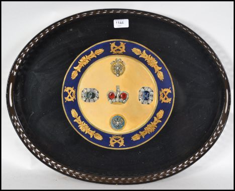 A good quality oval butlers tray having a fret pierced gallery surround and a central armorial coat of arms. Measures 52cm hi
