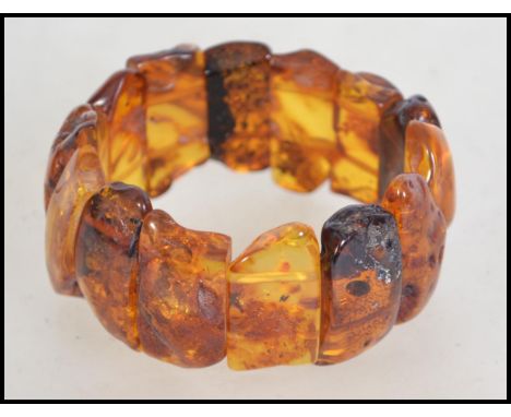 A vintage 20th century amber  plaque expanding bracelet, the plaques with inclusions  