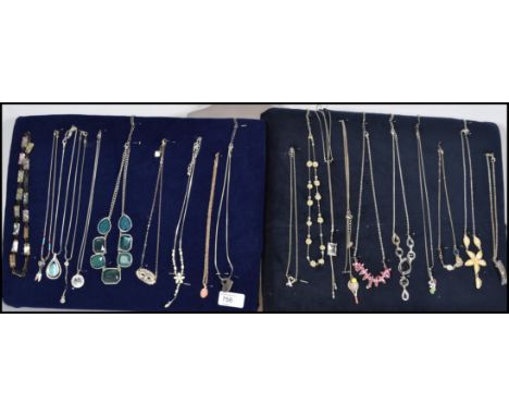 A collection of 20 silver and costume jewellery necklaces to include floral drop pendants, heart pendants, jade type panel ne